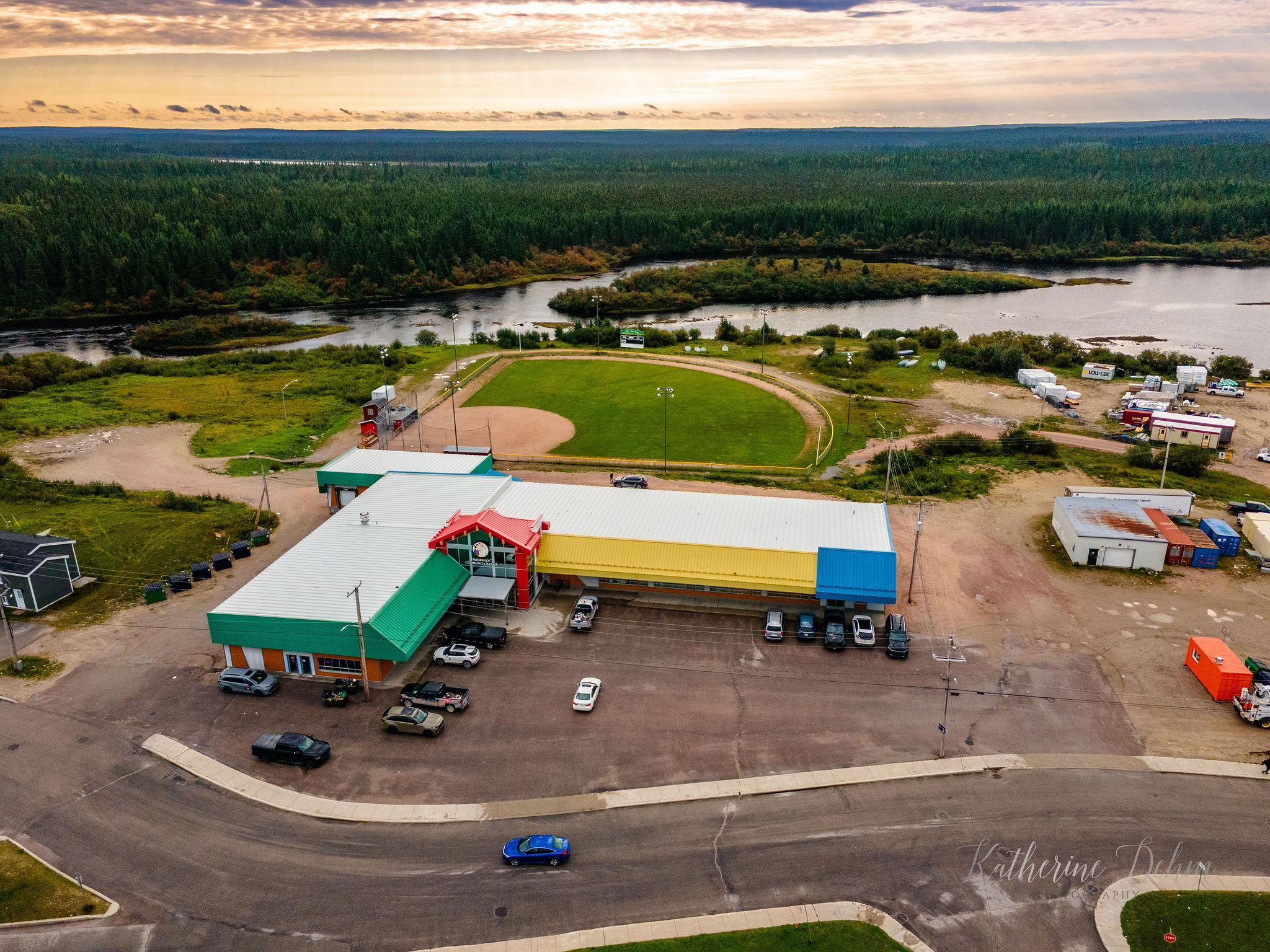 Aerial view of the Wemindji Community Store, ball field and the Maquatua River at sunset